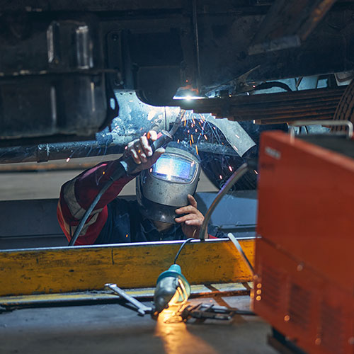 Man Welding Parts